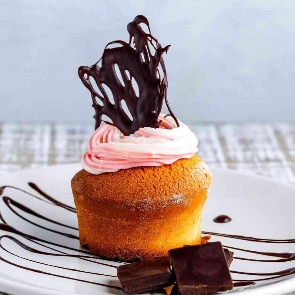 A cupcake topped with an allergy free chocolate decoration