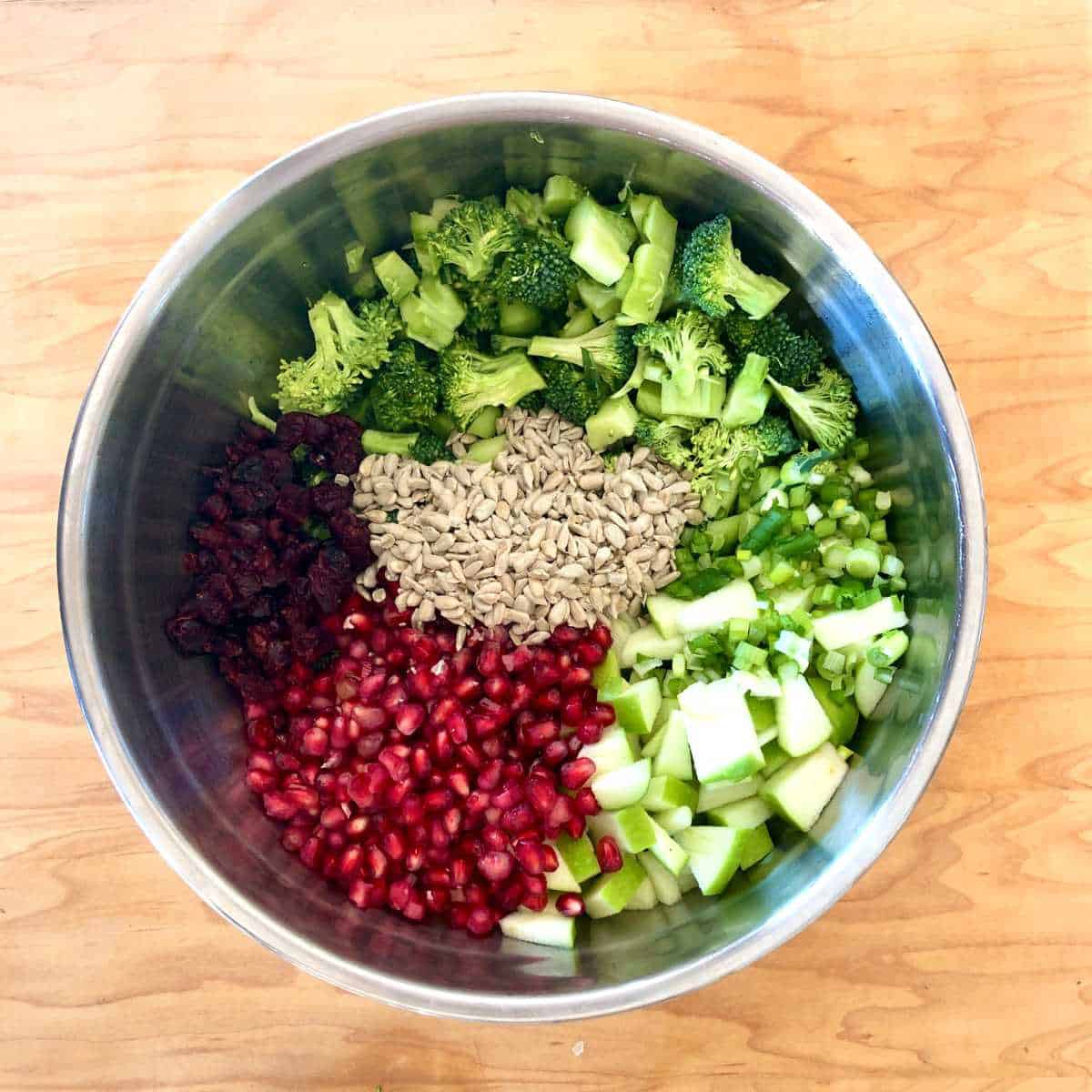 Ingredients for broccoli crunch salad in a large bowl.