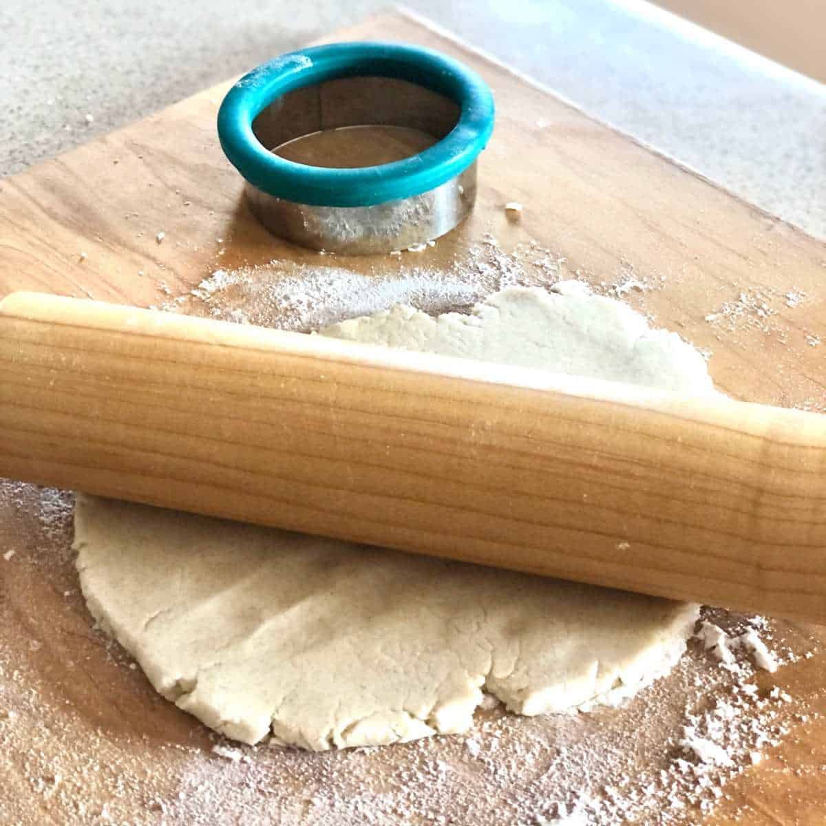 gluten and dairy free pie crust being rolled with a rolling pin