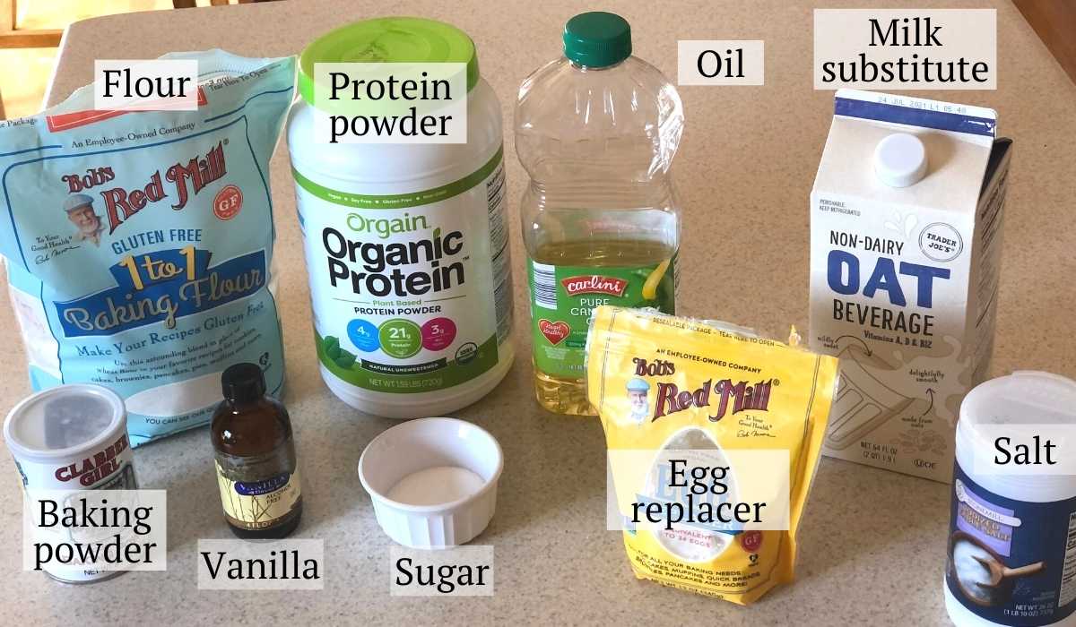 Waffle ingredients including gluten free flour, protein powder, baking powder, salt, sugar, egg replacer, milk substitute, oil, and vanilla.