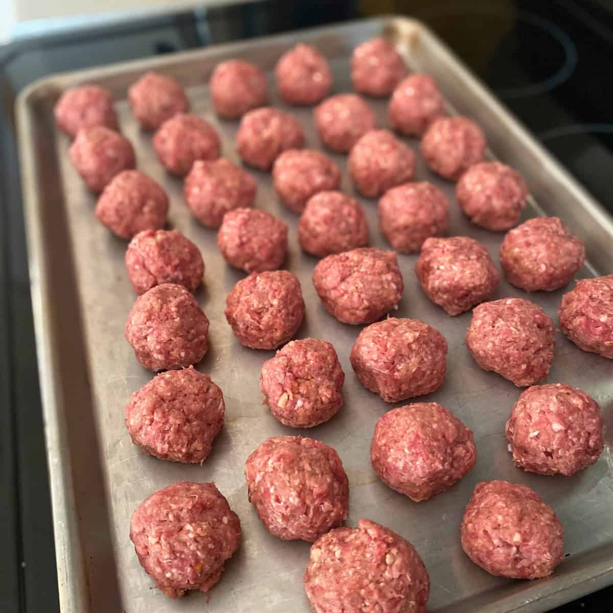 A baking sheet with formed Swedish meatballs