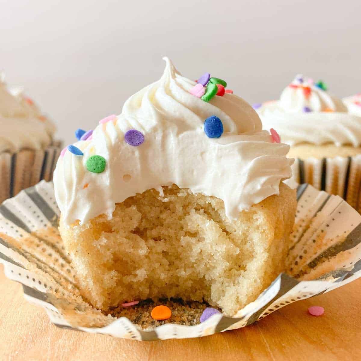 A cupcake with a bite out of it.