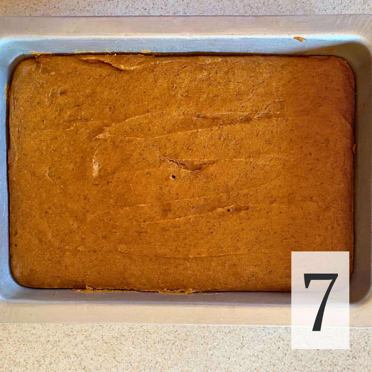 A pan of baked gluten free pumpkin bars cooling.