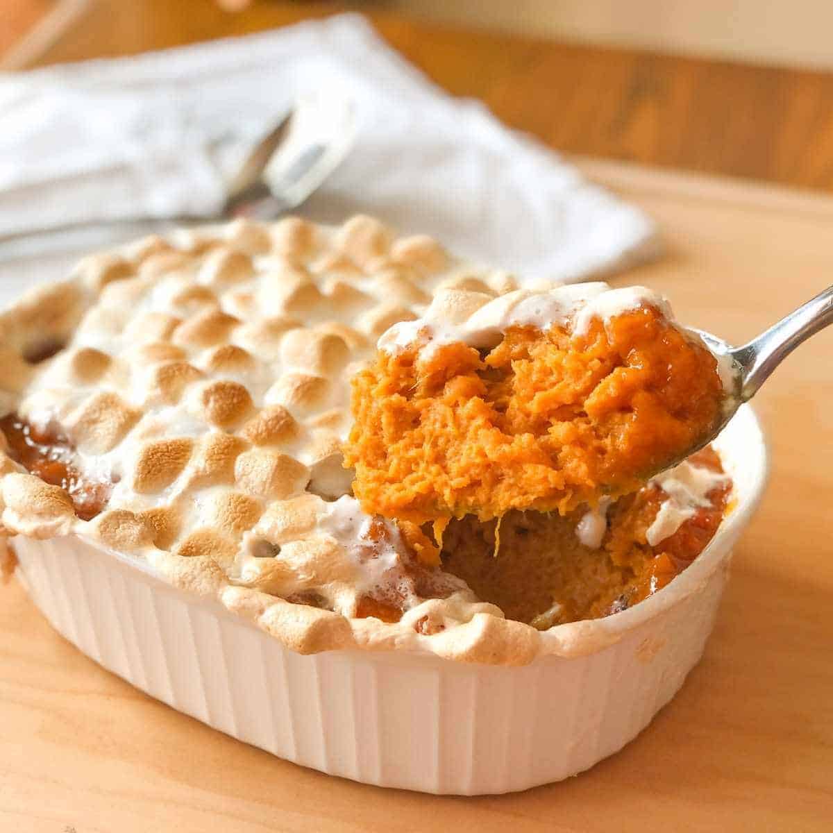 Sweet potato casserole on a serving spoon.