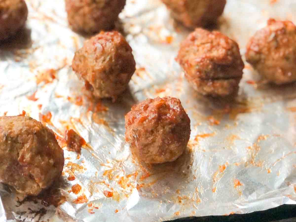 Gluten free turkey meatballs on a baking sheet.