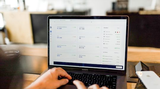 Computer with screen showing charts and graphs of advertising sales ppc campaigns and analysis