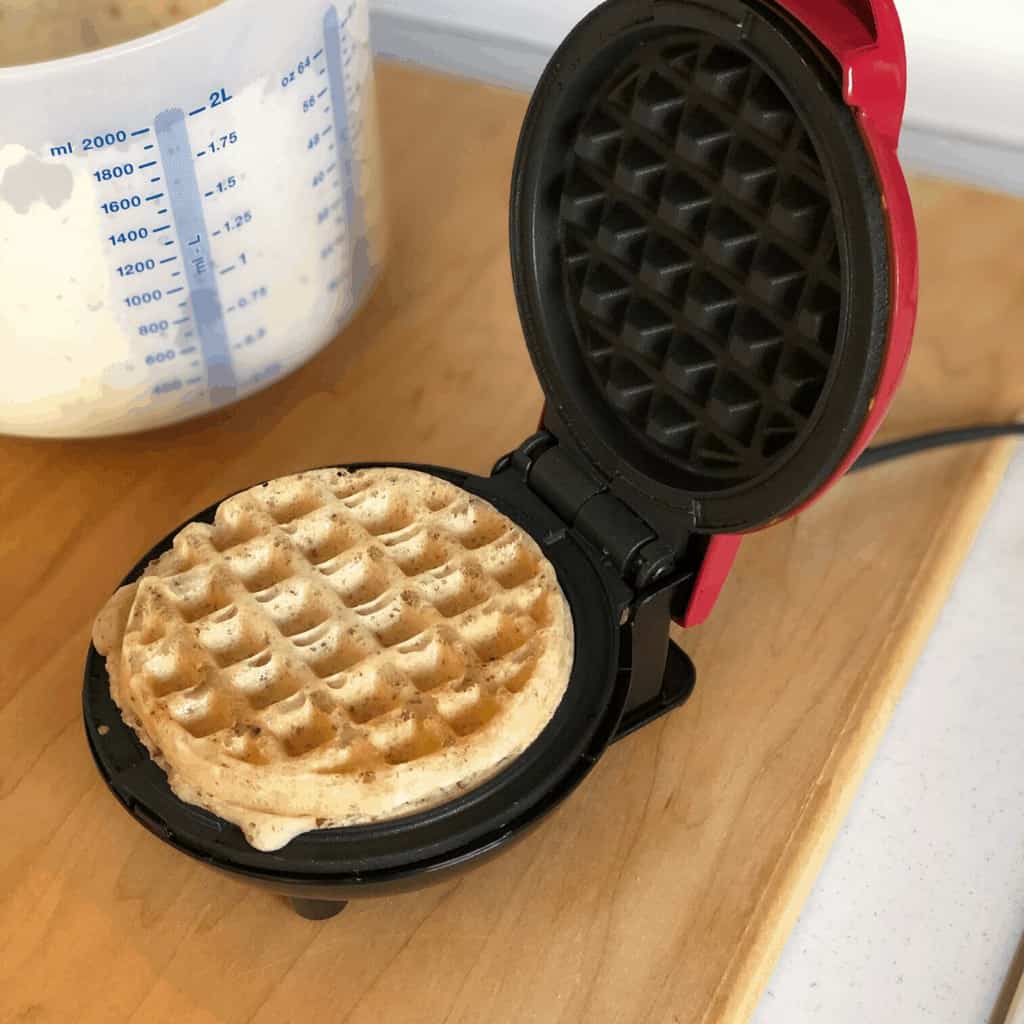A mini waffle maker with a waffle on it.