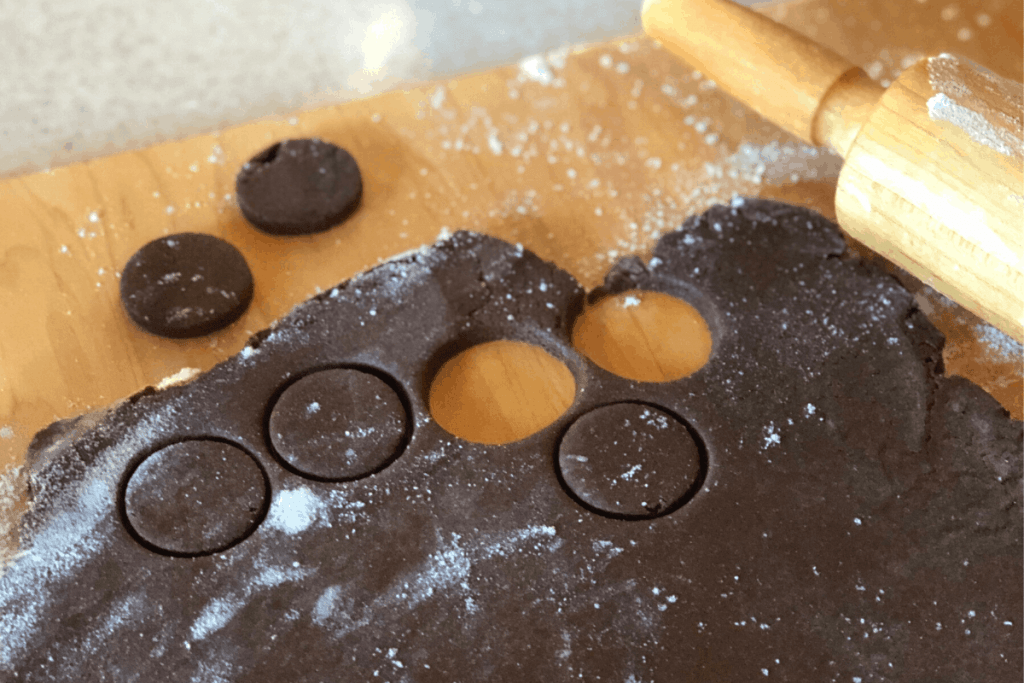 chocolate cookie dough being cut into circles