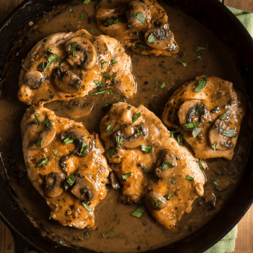 A pan with veal Marsala garnished with fresh parsley